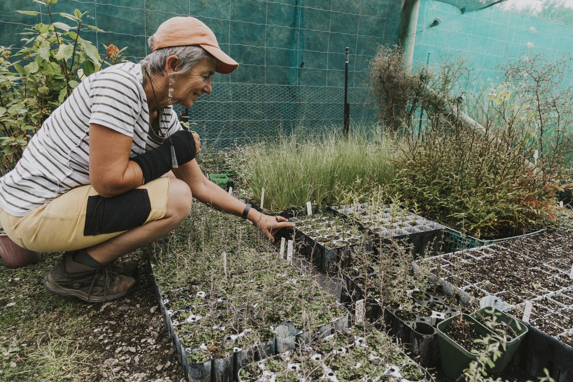 Woman planting at a local nursery.