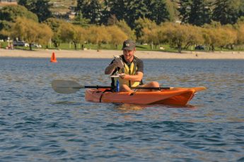 Man on kayak testing the water quality