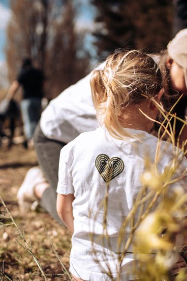 Mother and child planting a native seedling together