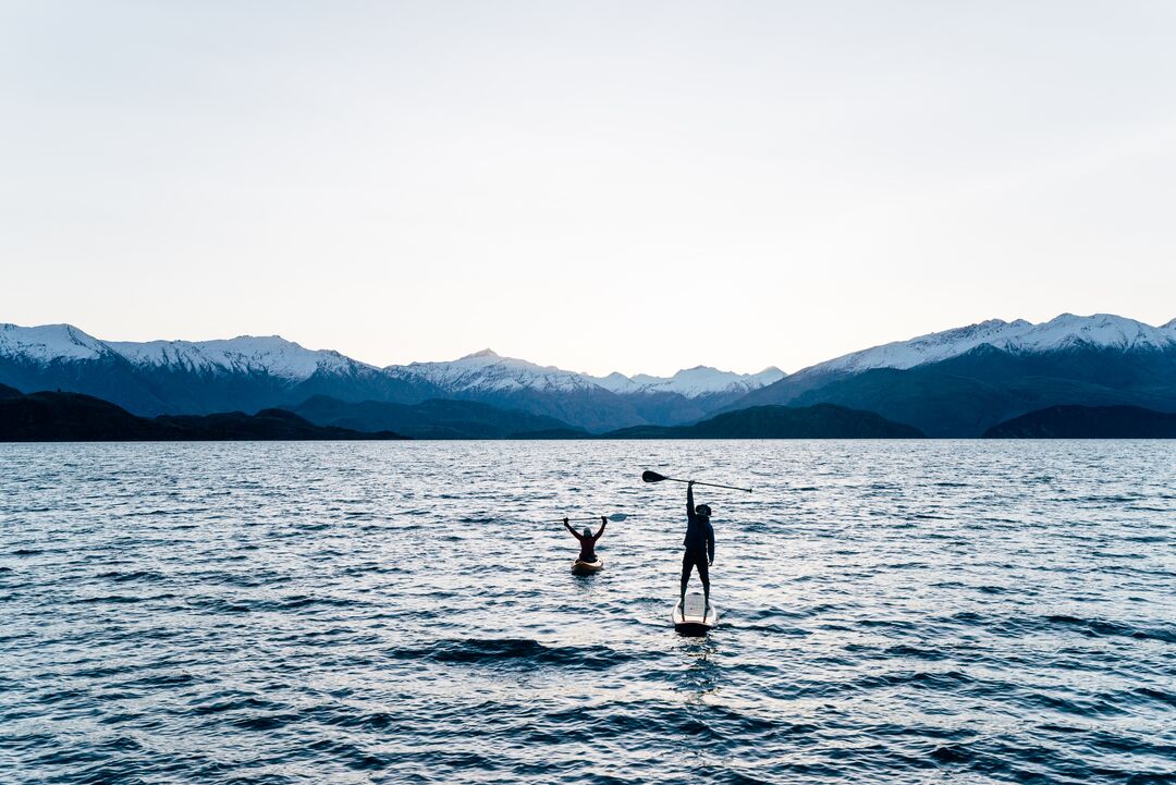 Paddle boarder at dusk on Lake Wānaka