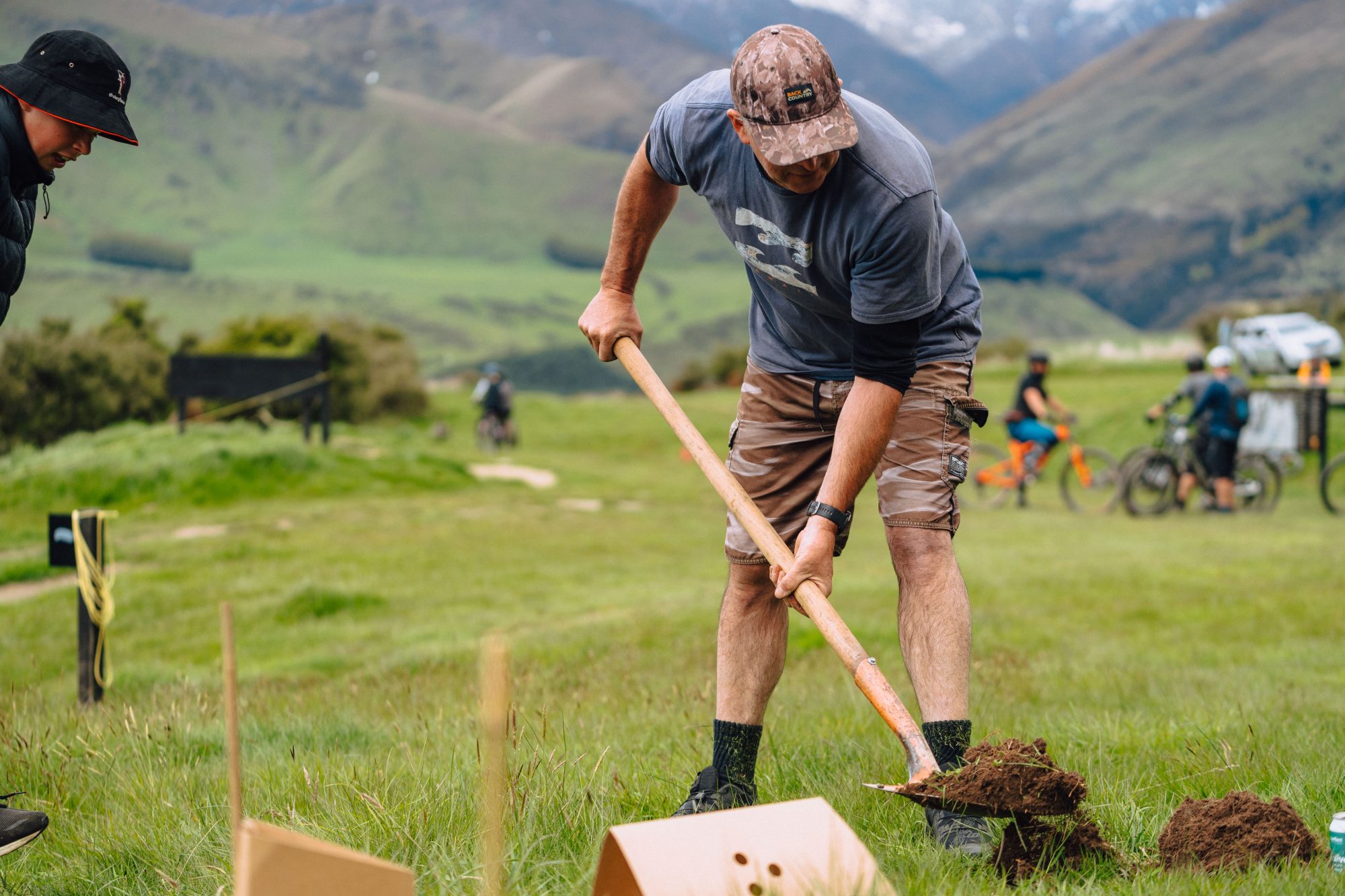 Volunteers from Love Wanaka Community Fund planting native trees at Bike Glendhu, contributing to trail-side restoration and environmental initiatives in Wānaka's mountain bike park