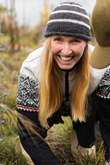 Volunteers working together to plant a native seedling at community planting day in Wānaka