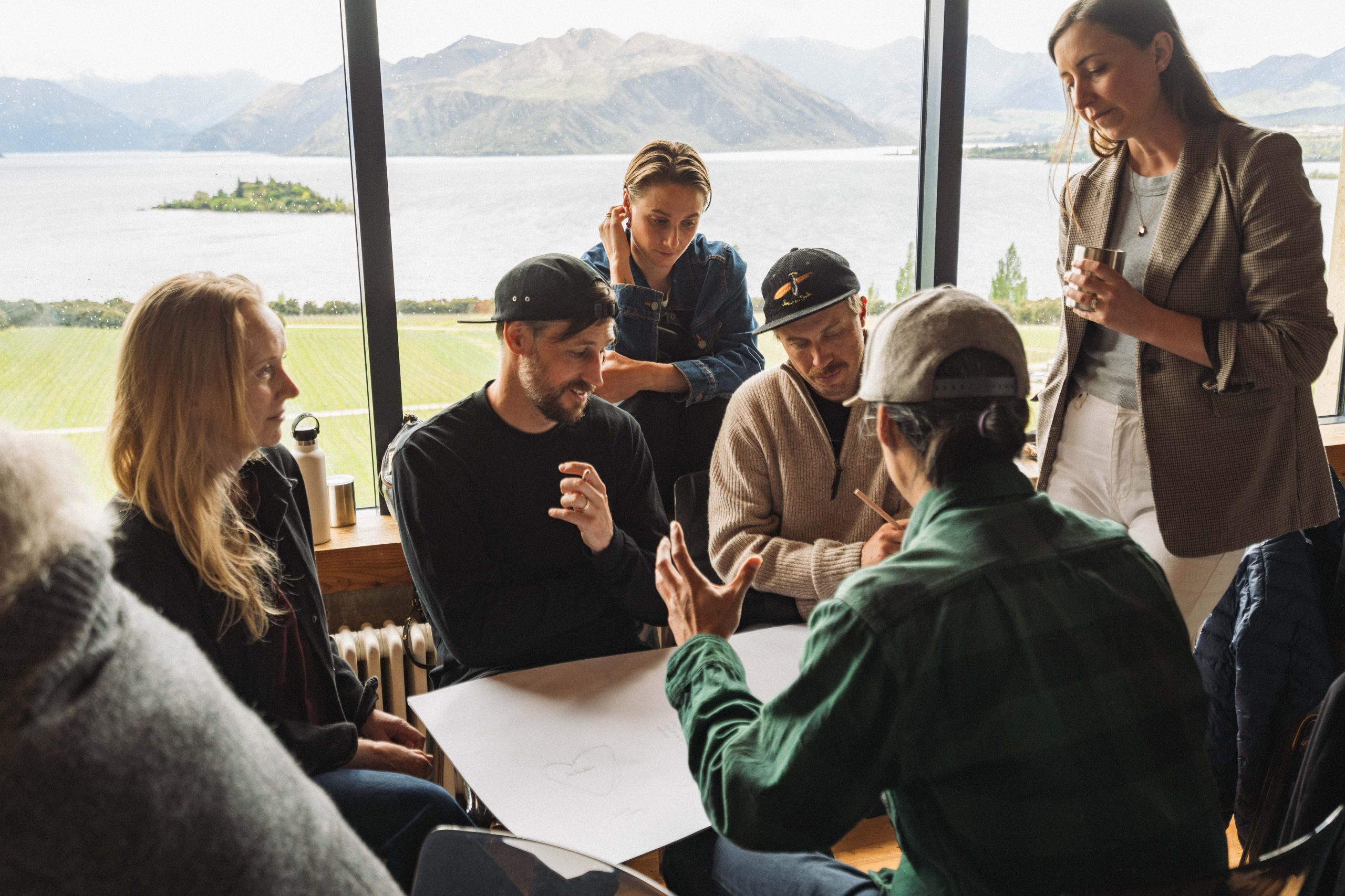 Group of people at a WAO Summit workshop in Wānaka, overlooking lake views