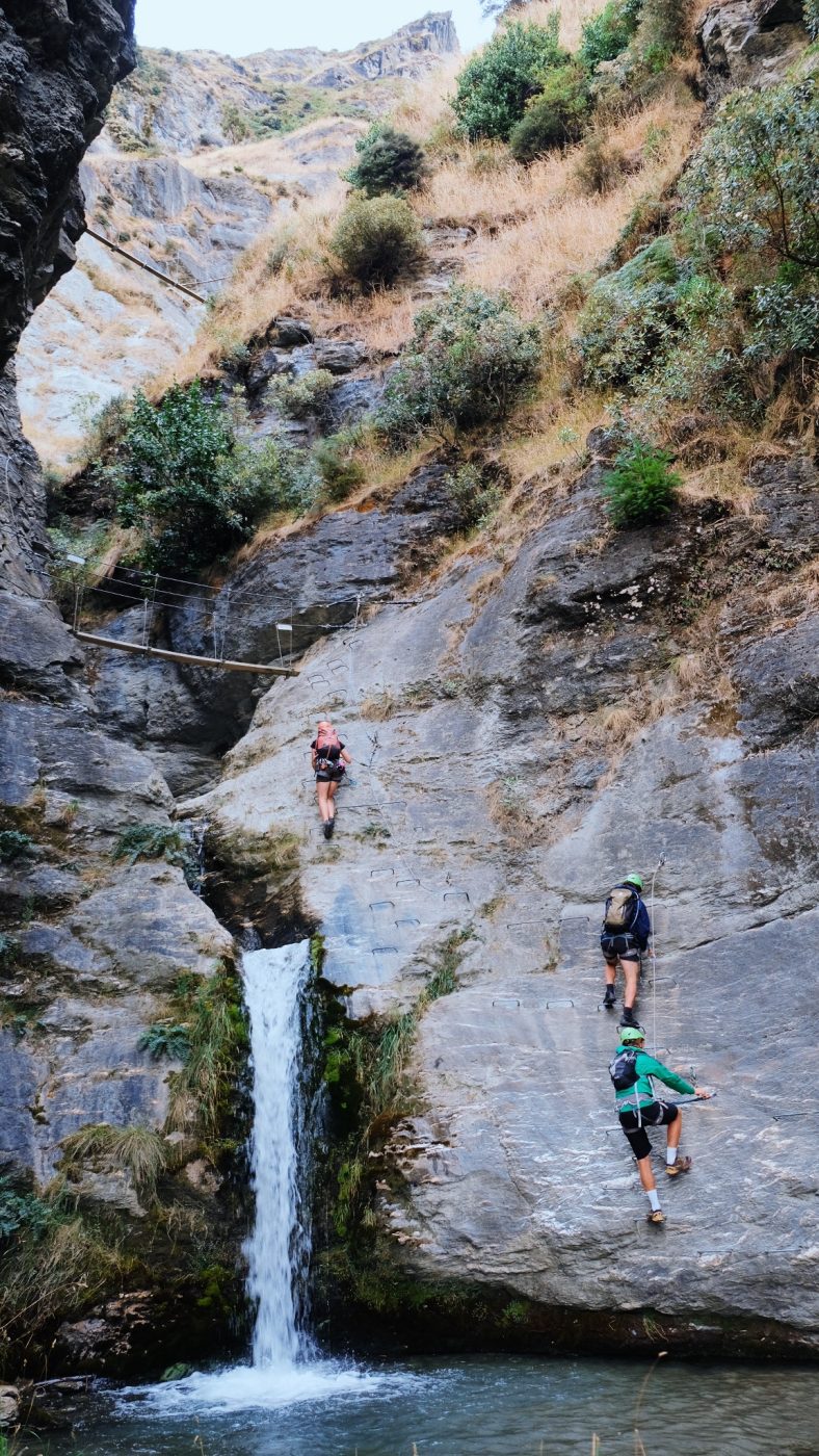 3 climbers climbing up a a rockface at Wildwire in Wānaka New Zealand