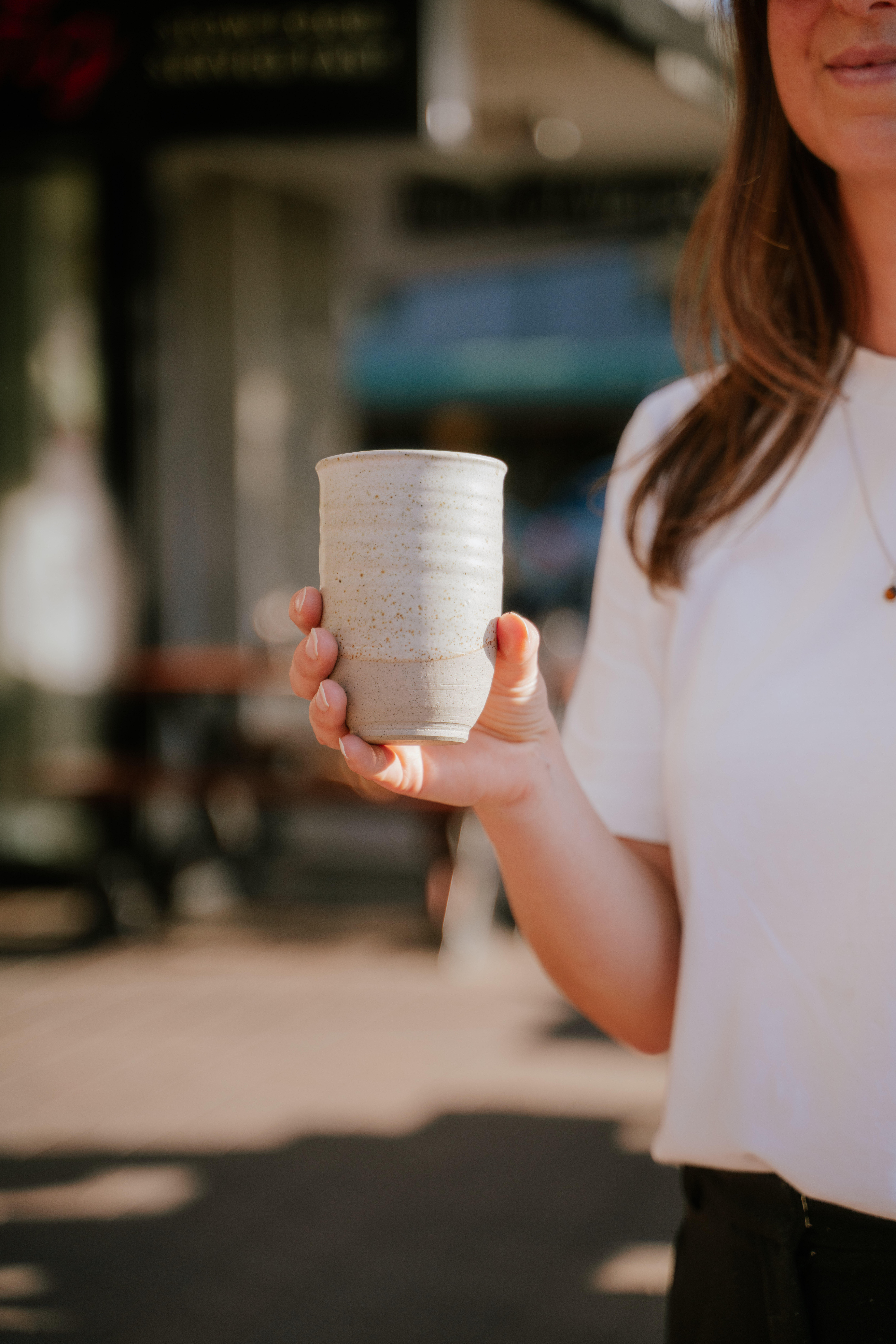 A hand holding a ceramic keep cup in Wānaka New Zealand