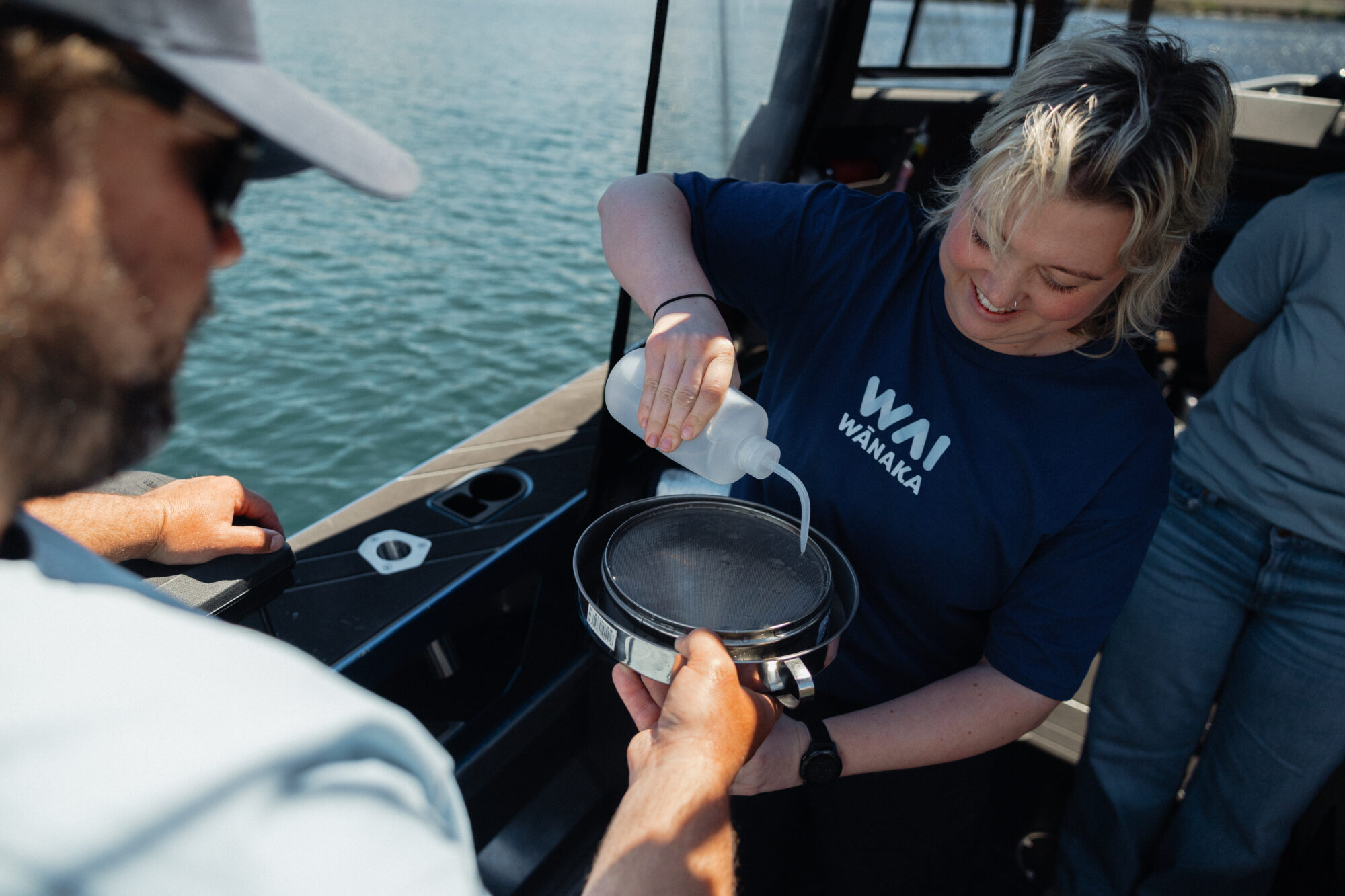 Wai Wānaka staff member conducts water sampling on Lake Wānaka